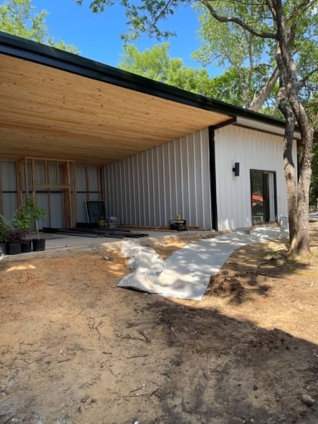 Barndominium exterior with covered porch under construction