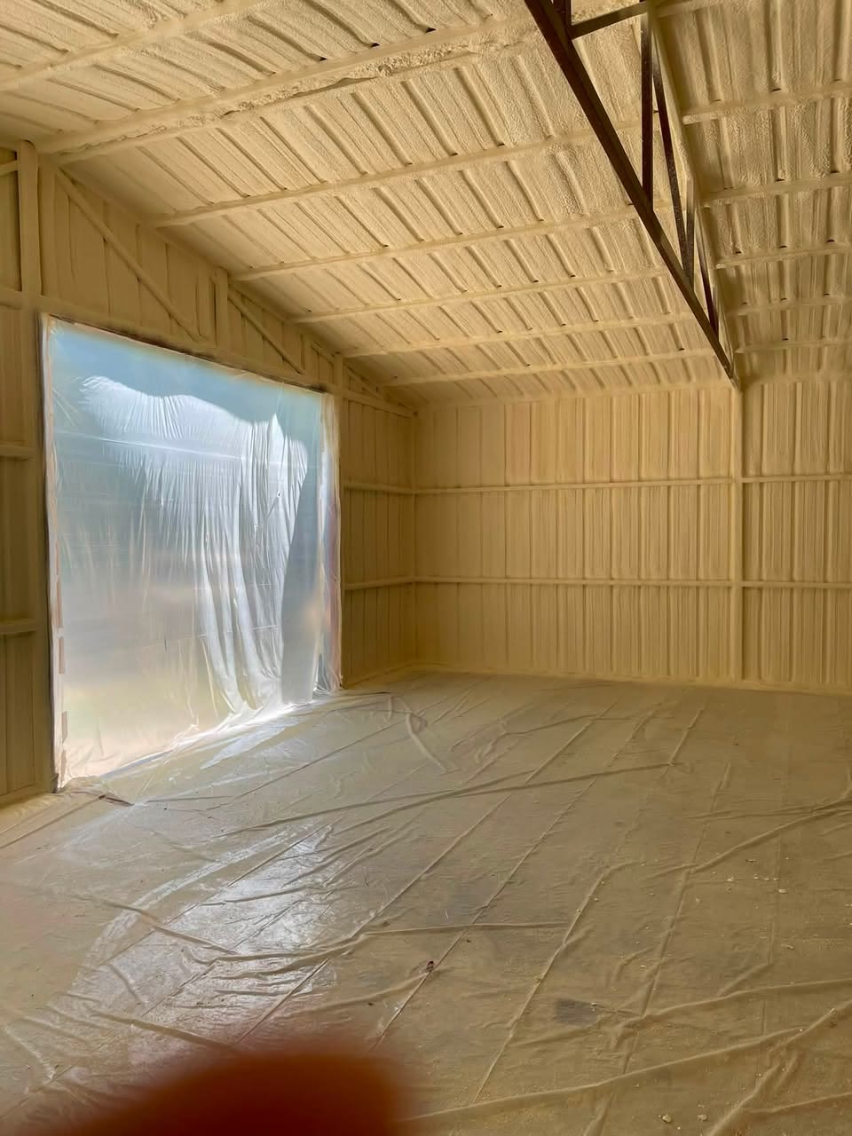 Metal building interior completely coated in spray foam insulation