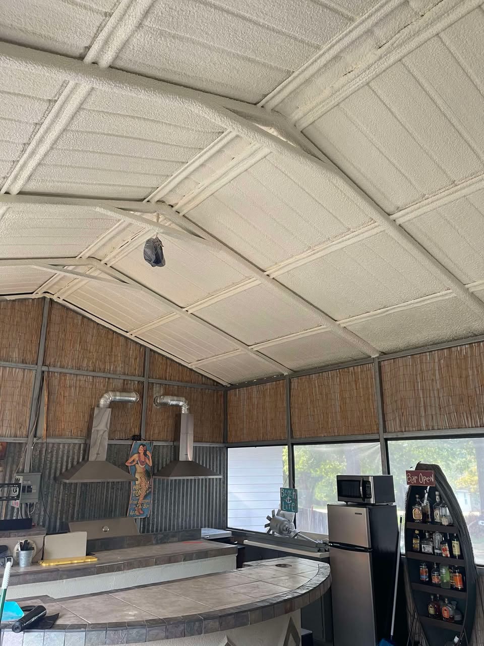 Outdoor kitchen and bar with a spray foam insulated ceiling